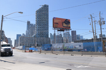 Naklejka premium roadside tower billboard for candy and distant view of Monde Condominiums, looking west on Queens Quay E, Toronto
