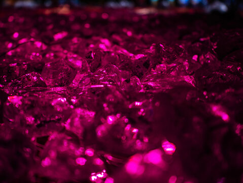 Abstract glowing pink crystals and gemstone texture in macro view with neon illumination