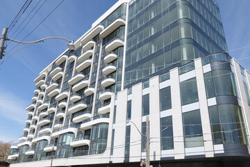 Naklejka premium the ANX at 328 Dupont Street, designed by Teeple Architects for Freed Developments in 2023, is a 13-storey Expressionist Modernist mixed-use condominium characterized by its undulating white aluminum 