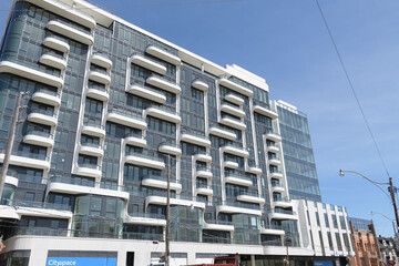 Naklejka premium the ANX at 328 Dupont Street, designed by Teeple Architects for Freed Developments in 2023, is a 13-storey Expressionist Modernist mixed-use condominium characterized by its undulating white aluminum 