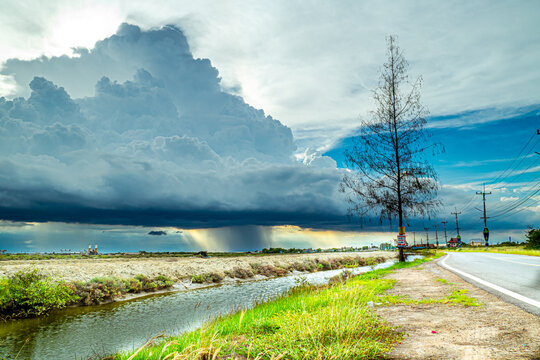 Dramatic Storm Clouds Looming Over Rural Roadway