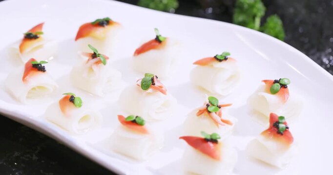 High-end creative cold dish: Arctic surf clam rolls with bamboo shoot slices garnished with caviar