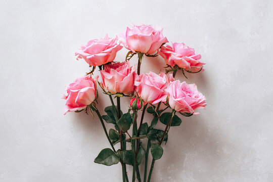 Bouquet of pink roses on a white background. Minimal composition. Flat lay 