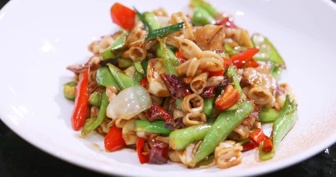 Stir-fried baby squid with green chili peppers, millet peppers, garlic sprouts, onions, and sauce