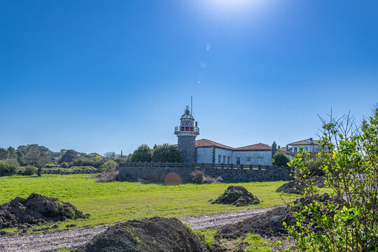 Faro de la galea lighthouse standing on a grassy field against a bright blue sky getxo vizcaya euskadi spain