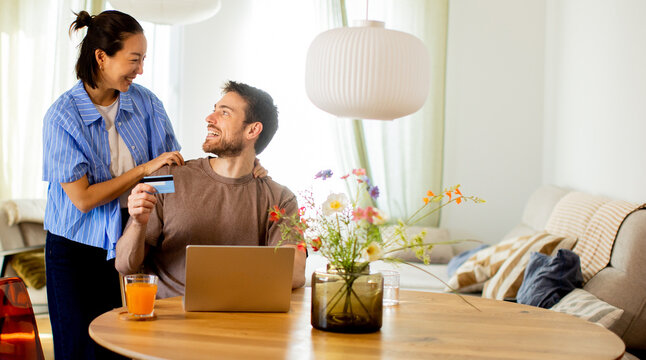 Couple prepares for online shopping at home during daytime