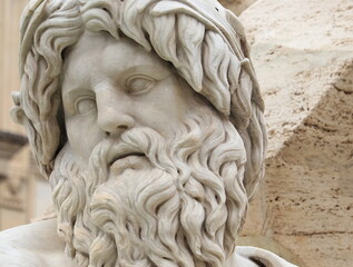 Naklejka premium Sculpted Bearderd Man's Head at the Fontana dei Quattro Fiumi Fountain in Rome, Italy