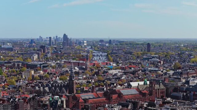 Aerial Amsterdam cityscape with historic buildings and modern Zuidas business district in Netherlands, famous De Klerk and Beurs van Berlage architecture