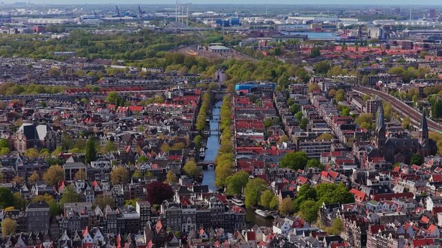 Amsterdam suburban houses, city canal, Port of Amsterdam in Netherlands showcasing urban landscape with parks and traditional gabled residential architecture from above