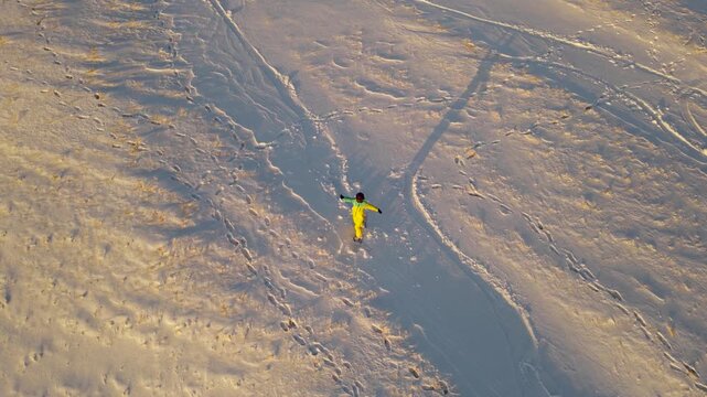 The girl is a snowboarder on the slope