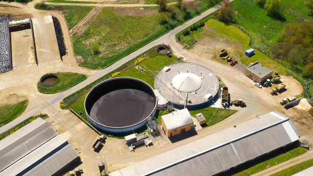Biogas plant and farm in fields. Renewable energy from biomass. Aerial view to Czech industry. Sustainable development in European Union.