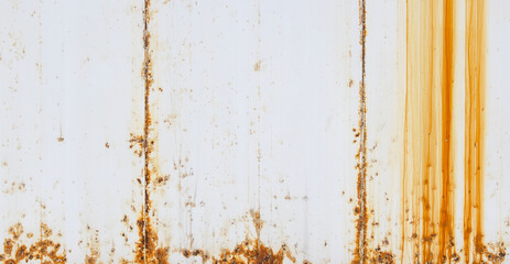 A high-resolution texture of a white painted full frame metal surface with heavy orange rust streaks and weathered grunge details, perfect for industrial backgrounds. Background Pattern. © Selim Aysolmaz
