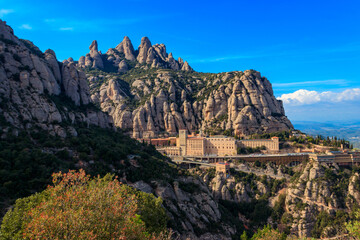 Fototapeta premium View of the famous Santa Maria de Montserrat Abbey located on the mountain of Montserrat nearby from Barcelona in Catalonia, Spain. Montserrat Monastery