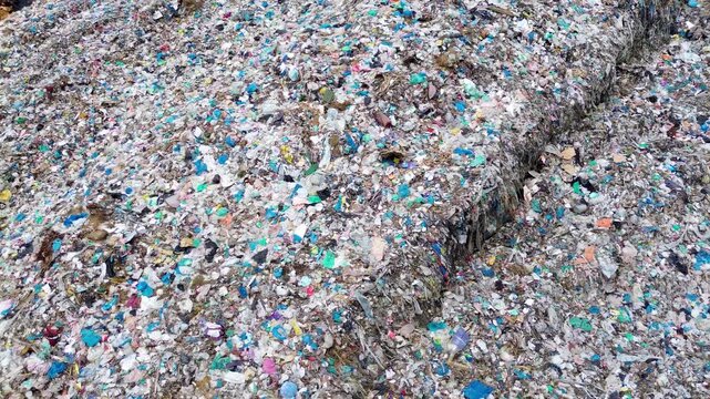Plastic waste texture forming landfill garbage background with environmental pollution aerial