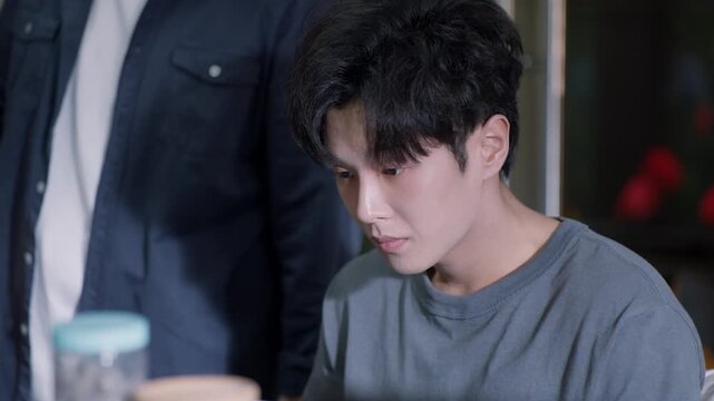 Desperate young asian man feeling depressed, grieving and crying after receiving bad news