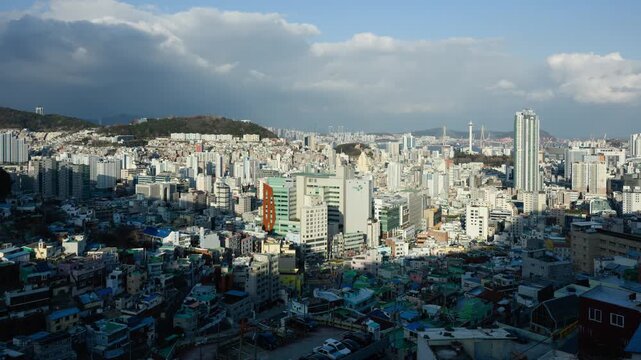 Busan Dramatic Sky Day to Night Timelapse Cityscape Skyline. Gureumi Swieoganeun Observatory view of a dense modern megacity skyline with glowing lights and changing weather.