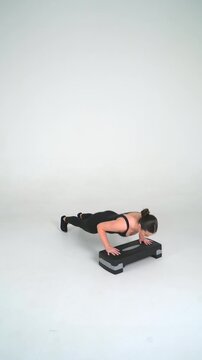 Incline Push-Up on Stepper - Female Fitness Model Workout on White Background, Seamless Loop