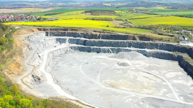 Stone quarry. Open cast mining. Industrial landscape. Heavy industry from above. Aerial view to big source of emissions.