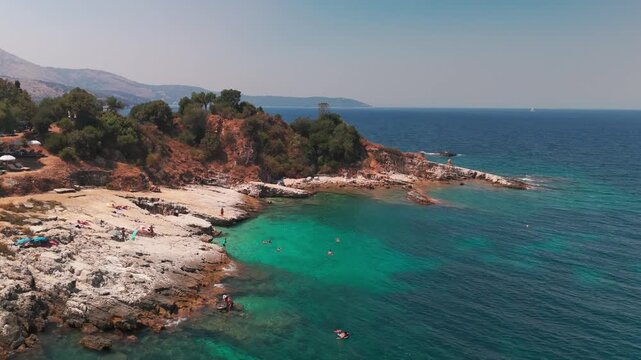 Aerial Tracking Shot of Secluded Kanoni Beach with Crystal Clear Turquoise Sea in Kassiopi Corfu
