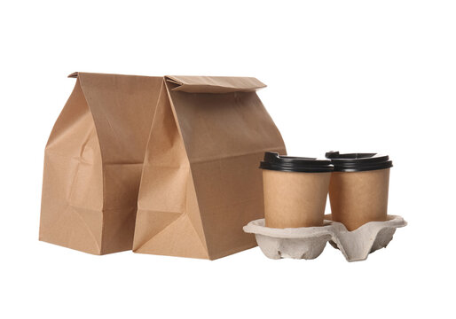 Brown paper takeout bag with two coffee cups in holder, food delivery isolated on transparent background PNG