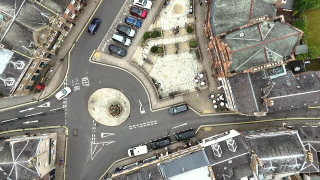 cars riding a roundabout in a quiet country village