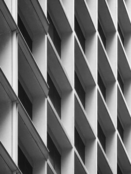 Rhythmic geometric patterns of a modern skyscraper facade create a bold architectural statement in Hong Kong.