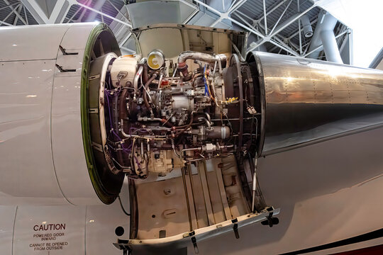 A jet engine with the cowling removed exposing inner workings, nobody