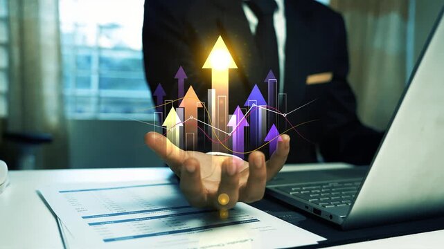 Business man working on laptop & hand holding glowing holographic arrow graph bar, Business growth concept with upward arrows and analytics hologram