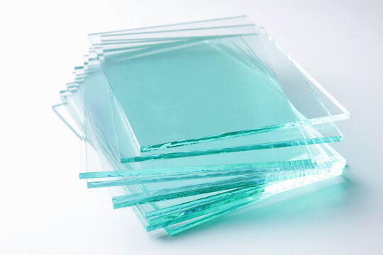 Stack of glass sheets on light background, closeup