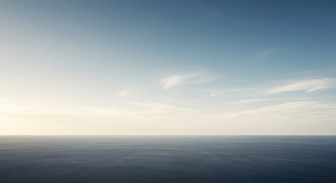Expansive, empty, and infinite horizon line meeting a seamless sky. A conceptual representation of potential, future, scale, and emptiness, solitude, future, background