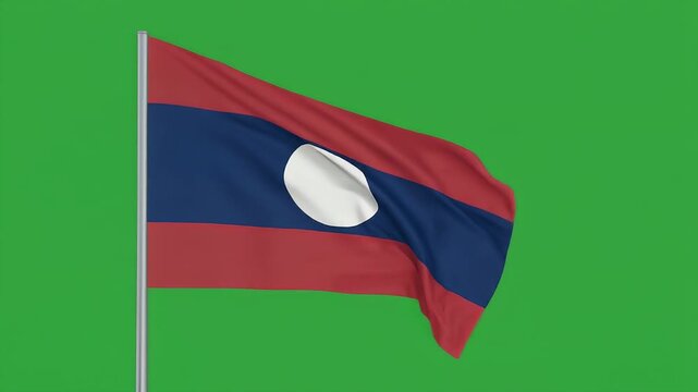 The Laotian flag waves gently on a pole against a green screen background