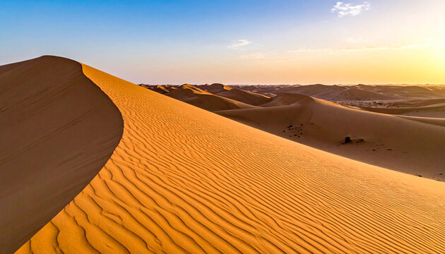 Golden sand dunes texture with wind in desert. Close-up view of golden desert sand dunes with natural wind patterns and smooth curves. Minimal and abstract landscape with copy space for design use.