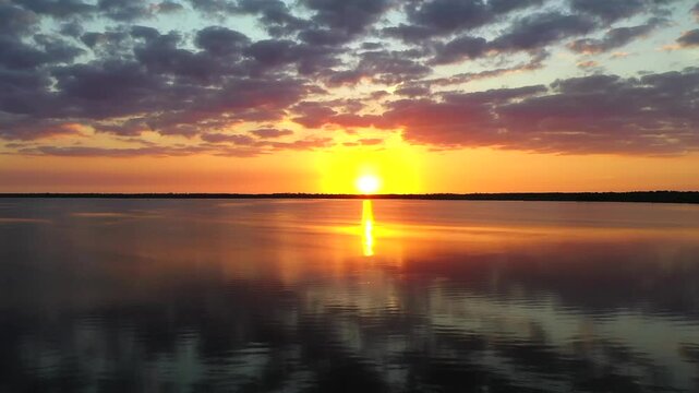  Aerial film over a lagoon at sunset
