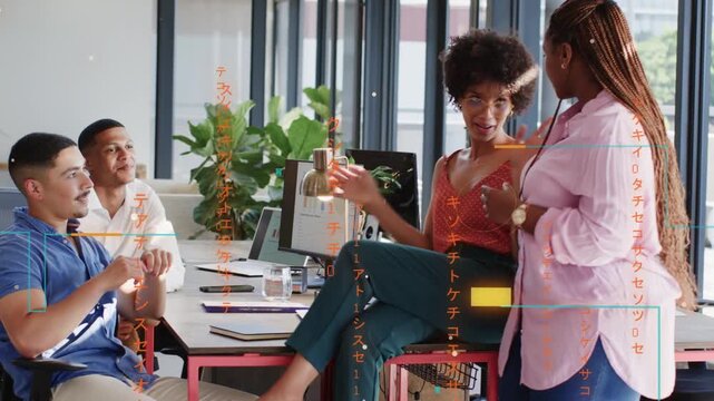 Woman entering from left sparking chat, perching on desk, pitching idea to coworkers in office