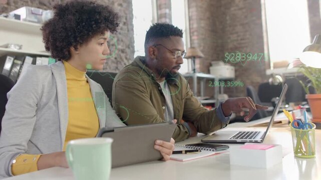 Woman holding tablet man pointing laptop causing business data reviewing, green overlays appearing