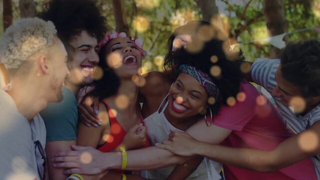 Laughter sparking six friends tightening hug in park event, golden bokeh drifting, celebrating