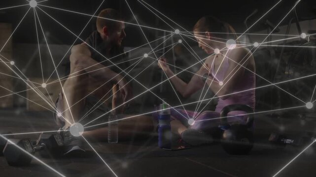 Woman reaching for water bottle as man leaning in, network overlay showing wearable for rehydration