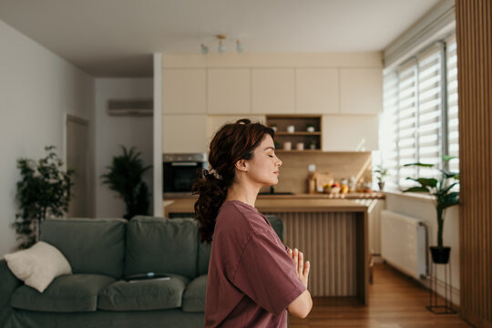 Woman meditating at home finding zen and relaxation