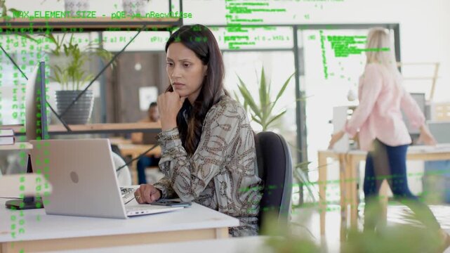Office woman typing on laptop, keystrokes spawning green code overlay spreading visualizing data