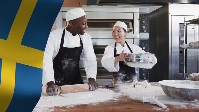 Team baking woman tipping sifter dusting dough while man rolling dough Swedish flag overlaying left