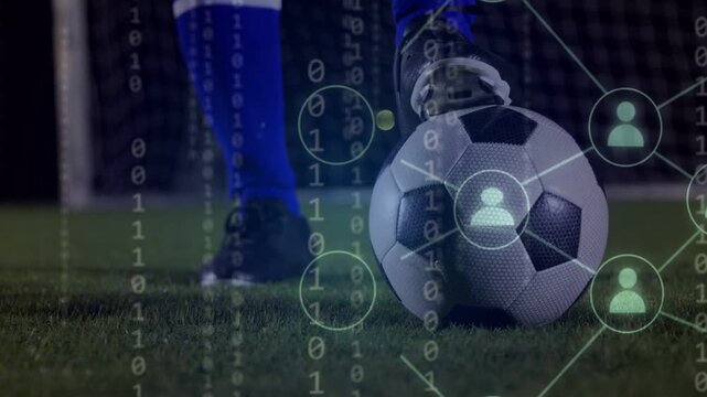 Binary digits appearing network overlaying ball soccer player planting foot preparing shot at goal