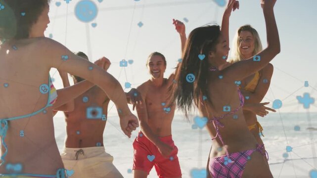 Man in red trunks cheering, initiating group dancing on beach for marketing, blue icons overlaying
