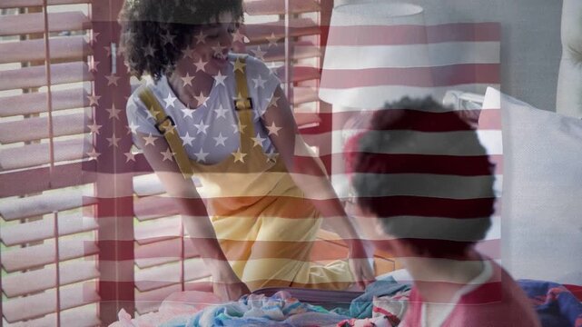 Woman spreading clothes on bed, sorting with seated person, helping pick fashion under US flag