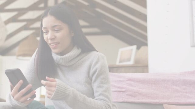 Woman reading incoming text on phone in loft under beams, laughing, gesturing for communication