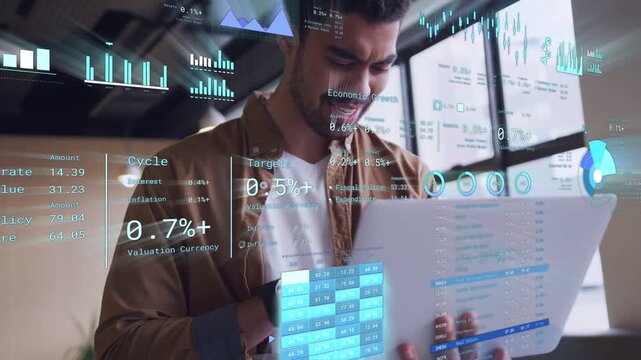 Male analyst holding tablet tapping phone updating holo charts analyzing % stats for finance review