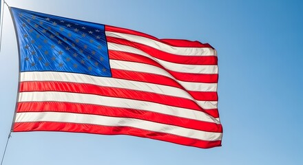 Obraz premium American flag waving against a clear blue sky
