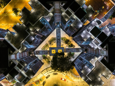 Stunning aerial night view of glowing high rise residential towers in Hong Kong showcases dense urban living and modern architectural scale.