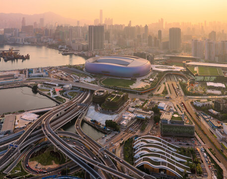 The modern Kai Tak Sports Park in Hong Kong glows during a golden sunset, showcasing the city world class sports infrastructure and urban development.