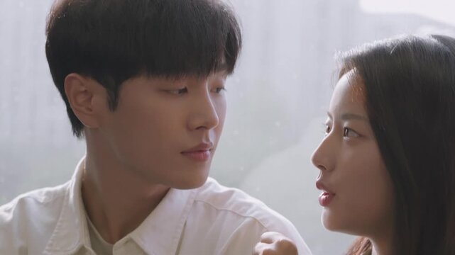 Close up of a tender young asian couple smiling, talking, and looking lovingly at each other