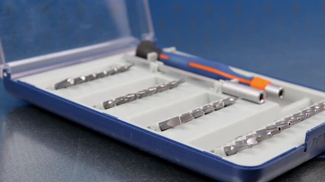 A set of tools with bits in a plastic case.